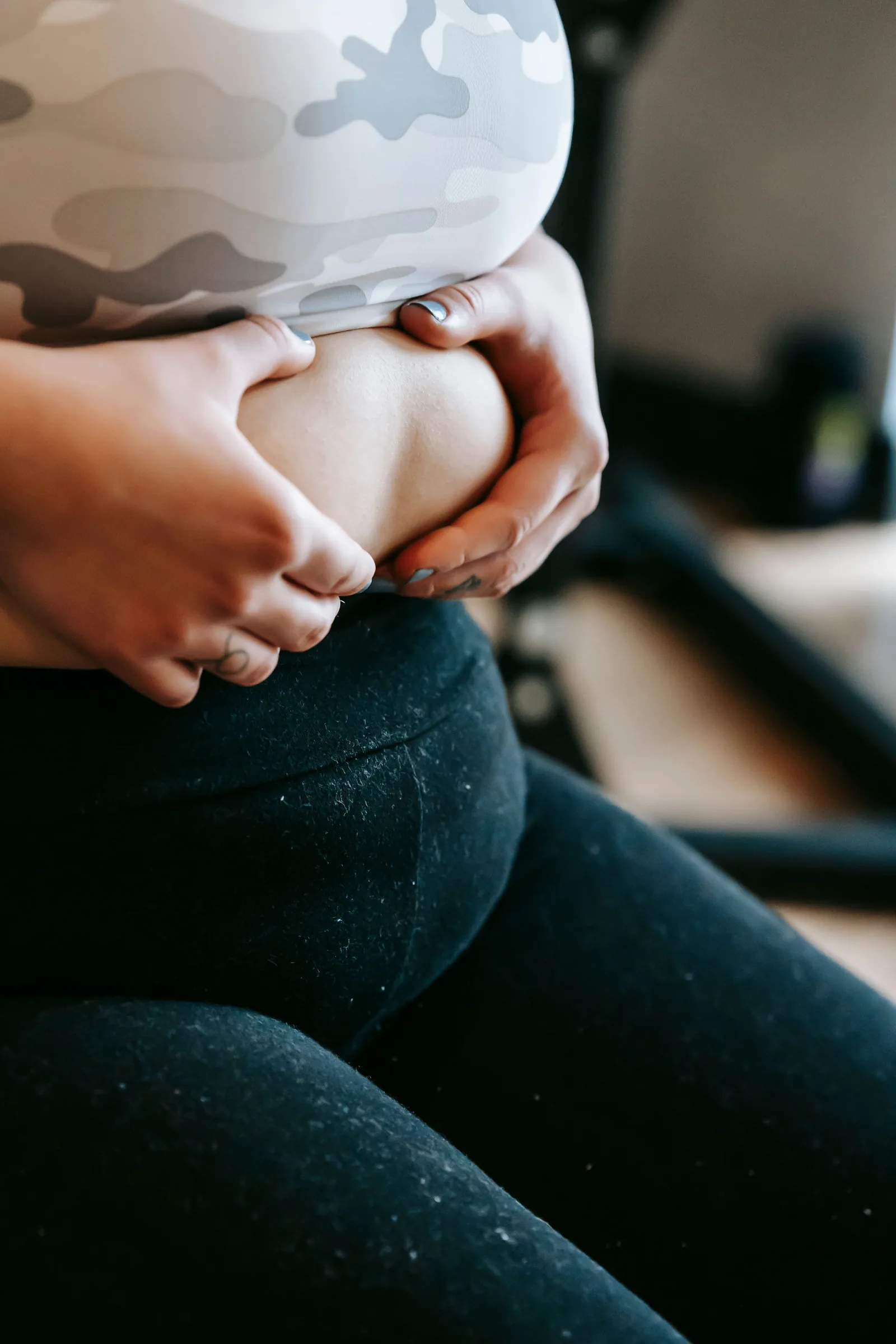 Holding the midsection while seated in a gym
