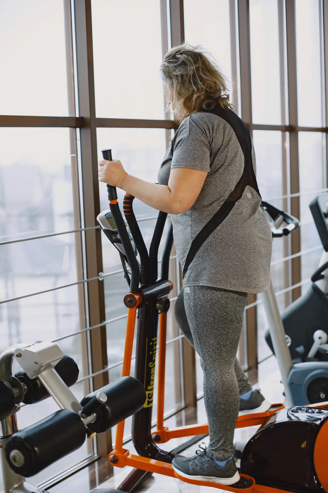Using an elliptical machine at the gym